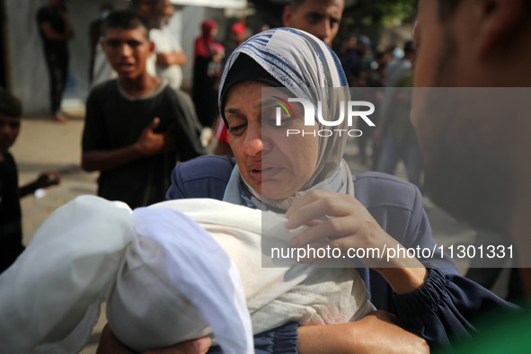 Palestinians are mourning their relatives, killed by an Israeli army strike the previous night, during a funeral at the Al-Aqsa Martyrs Hosp...