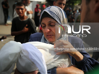 Palestinians are mourning their relatives, killed by an Israeli army strike the previous night, during a funeral at the Al-Aqsa Martyrs Hosp...