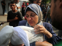 Palestinians are mourning their relatives, killed by an Israeli army strike the previous night, during a funeral at the Al-Aqsa Martyrs Hosp...