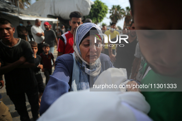 Palestinians are mourning their relatives, killed by an Israeli army strike the previous night, during a funeral at the Al-Aqsa Martyrs Hosp...