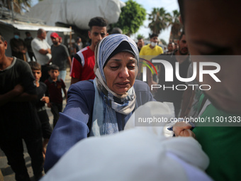 Palestinians are mourning their relatives, killed by an Israeli army strike the previous night, during a funeral at the Al-Aqsa Martyrs Hosp...