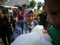 Palestinians are mourning their relatives, killed by an Israeli army strike the previous night, during a funeral at the Al-Aqsa Martyrs Hosp...