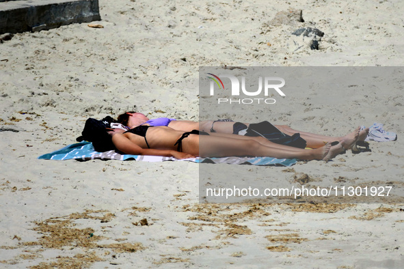 People are relaxing on the beach next to a newly opened bomb shelter in Odesa, Ukraine, on May 31, 2024. NO USE RUSSIA. NO USE BELARUS. 