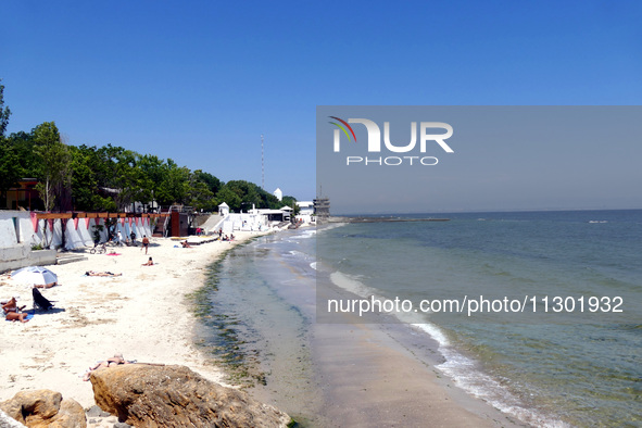 People are relaxing on the beach next to a newly opened bomb shelter in Odesa, Ukraine, on May 31, 2024. NO USE RUSSIA. NO USE BELARUS. 