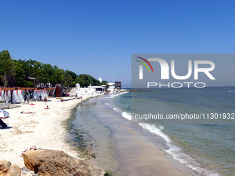 People are relaxing on the beach next to a newly opened bomb shelter in Odesa, Ukraine, on May 31, 2024. NO USE RUSSIA. NO USE BELARUS. (