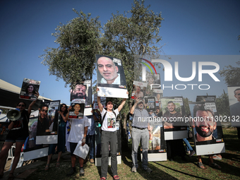 Relatives and friends of Israelis held hostage by Palestinian Hamas militants in the Gaza Strip are gathering to listen to the Israeli Finan...