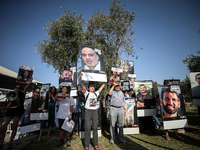 Relatives and friends of Israelis held hostage by Palestinian Hamas militants in the Gaza Strip are gathering to listen to the Israeli Finan...