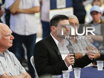 Israel's Finance Minister Bezalel Smotric is looking on as he addresses the relatives of Israelis being held hostage by Palestinian Hamas mi...