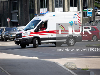 An ambulance is struggling through the traffic in the street of Kyiv, capital of Ukraine, in Kyiv, Ukraine, on June 3, 2024. NO USE RUSSIA....