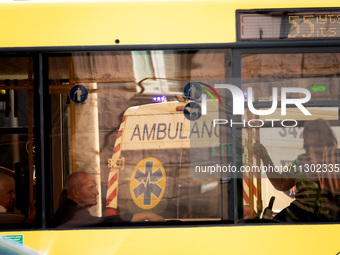 An ambulance is being reflected in a bus window in Kyiv, Ukraine, on June 3, 2024. NO USE RUSSIA. NO USE BELARUS. (