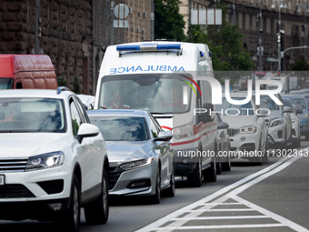 An ambulance is struggling through the traffic in the street of Kyiv, capital of Ukraine, in Kyiv, Ukraine, on June 3, 2024. NO USE RUSSIA....