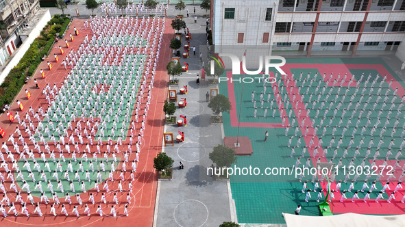 Students are practicing martial arts during a class break at the Second Experimental Primary School in Guanyun County, Lianyungang city, in...