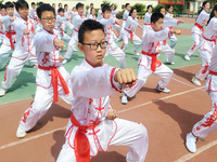 Students are practicing martial arts during a class break at the Second Experimental Primary School in Guanyun County, Lianyungang city, in...