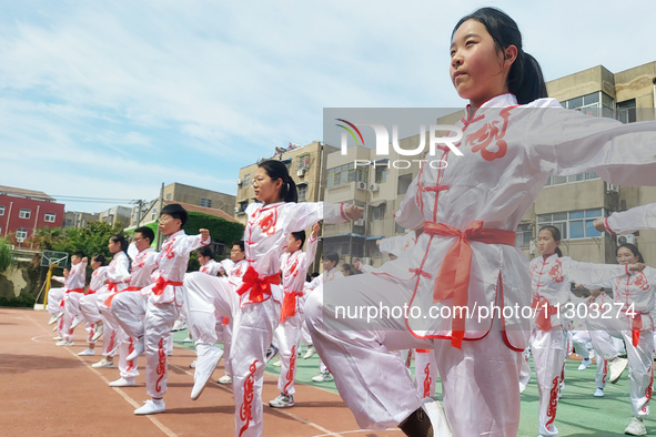 Students are practicing martial arts during a class break at the Second Experimental Primary School in Guanyun County, Lianyungang city, in...