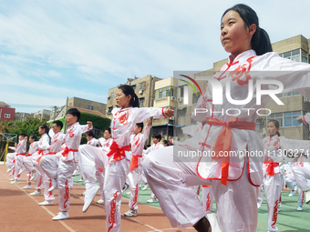 Students are practicing martial arts during a class break at the Second Experimental Primary School in Guanyun County, Lianyungang city, in...