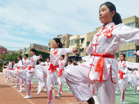 Students are practicing martial arts during a class break at the Second Experimental Primary School in Guanyun County, Lianyungang city, in...