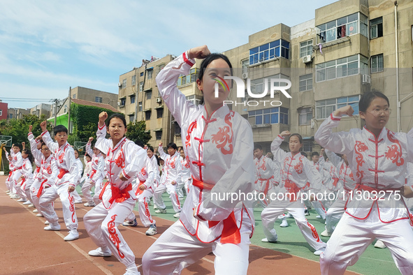 Students are practicing martial arts during a class break at the Second Experimental Primary School in Guanyun County, Lianyungang city, in...