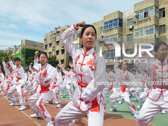 Students are practicing martial arts during a class break at the Second Experimental Primary School in Guanyun County, Lianyungang city, in...