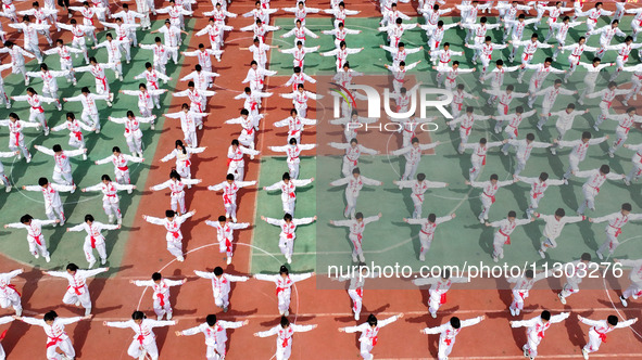 Students are practicing martial arts during a class break at the Second Experimental Primary School in Guanyun County, Lianyungang city, in...