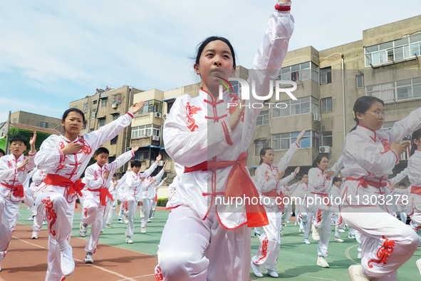 Students are practicing martial arts during a class break at the Second Experimental Primary School in Guanyun County, Lianyungang city, in...