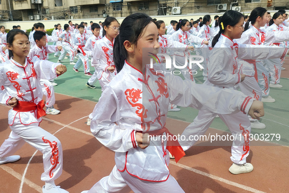 Students are practicing martial arts during a class break at the Second Experimental Primary School in Guanyun County, Lianyungang city, in...