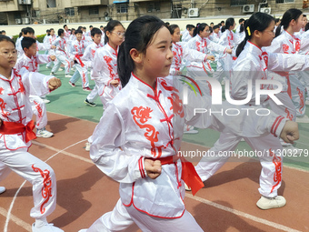 Students are practicing martial arts during a class break at the Second Experimental Primary School in Guanyun County, Lianyungang city, in...