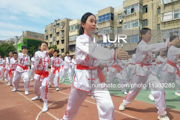 Students are practicing martial arts during a class break at the Second Experimental Primary School in Guanyun County, Lianyungang city, in...