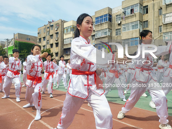 Students are practicing martial arts during a class break at the Second Experimental Primary School in Guanyun County, Lianyungang city, in...