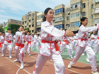 Students are practicing martial arts during a class break at the Second Experimental Primary School in Guanyun County, Lianyungang city, in...