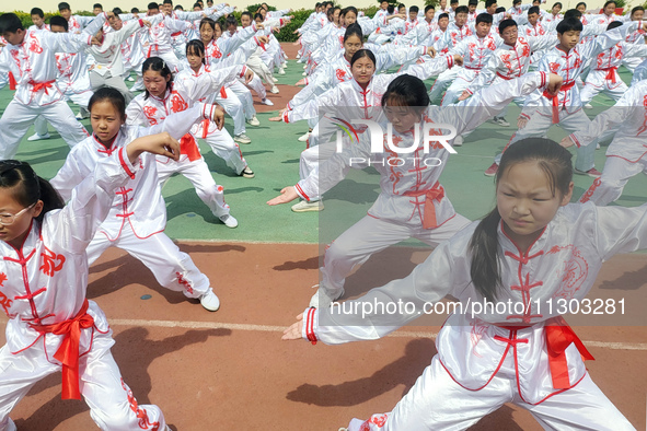 Students are practicing martial arts during a class break at the Second Experimental Primary School in Guanyun County, Lianyungang city, in...