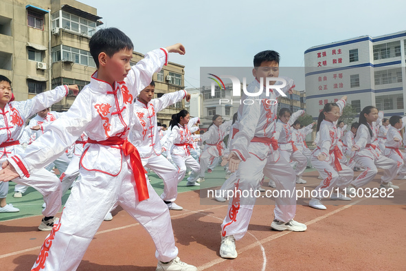 Students are practicing martial arts during a class break at the Second Experimental Primary School in Guanyun County, Lianyungang city, in...