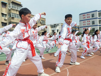 Students are practicing martial arts during a class break at the Second Experimental Primary School in Guanyun County, Lianyungang city, in...