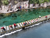 Volunteers are picking up debris at the Black Dragon Cave Scenic spot in Handan, China, on June 4, 2024. (