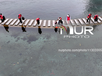 Volunteers are picking up debris at the Black Dragon Cave Scenic spot in Handan, China, on June 4, 2024. (