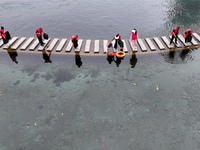 Volunteers are picking up debris at the Black Dragon Cave Scenic spot in Handan, China, on June 4, 2024. (