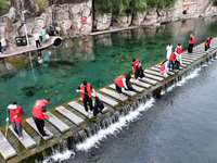 Volunteers are picking up debris at the Black Dragon Cave Scenic spot in Handan, China, on June 4, 2024. (