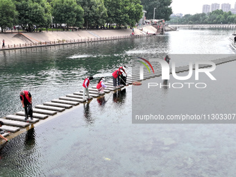 Volunteers are picking up debris at the Black Dragon Cave Scenic spot in Handan, China, on June 4, 2024. (