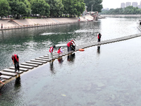 Volunteers are picking up debris at the Black Dragon Cave Scenic spot in Handan, China, on June 4, 2024. (