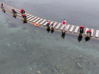 Volunteers are picking up debris at the Black Dragon Cave Scenic spot in Handan, China, on June 4, 2024. (