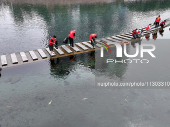 Volunteers are picking up debris at the Black Dragon Cave Scenic spot in Handan, China, on June 4, 2024. (