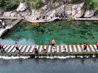 Volunteers are picking up debris at the Black Dragon Cave Scenic spot in Handan, China, on June 4, 2024. (