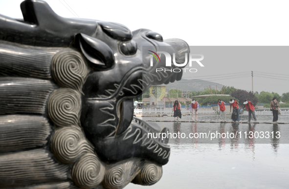 Volunteers are picking up debris at the Black Dragon Cave Scenic spot in Handan, China, on June 4, 2024. 