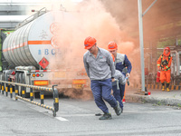 A company's emergency personnel are transferring the injured during a fire emergency drill in Deqing County, Huzhou city, Zhejiang province,...