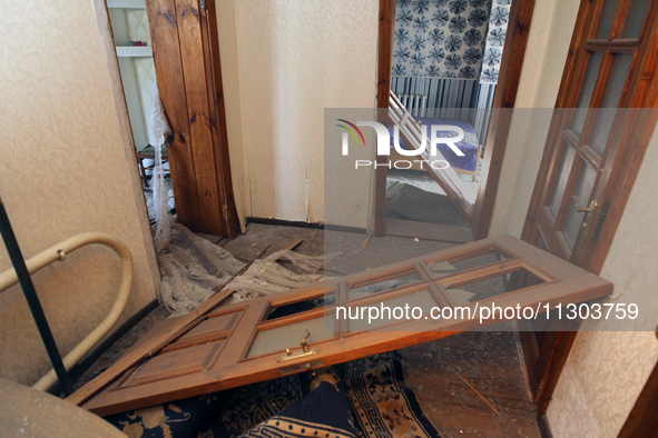 A knocked-out door is being seen in a house after a nighttime Russian missile strike in Dnipro, Ukraine, on June 4, 2024. Ukraine's air defe...