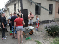 Locals are gathering outside a house damaged by the falling debris of downed Russian missiles in Dnipro, Ukraine, on June 4, 2024. As report...