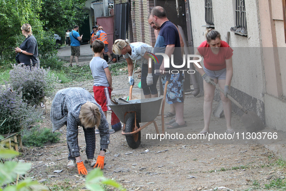 People are removing the debris following a nighttime Russian missile strike in Dnipro, Ukraine, on June 4, 2024. Ukraine's air defense force...