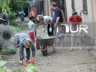 People are removing the debris following a nighttime Russian missile strike in Dnipro, Ukraine, on June 4, 2024. Ukraine's air defense force...