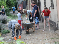 People are removing the debris following a nighttime Russian missile strike in Dnipro, Ukraine, on June 4, 2024. Ukraine's air defense force...