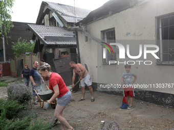 People are removing the debris following a nighttime Russian missile strike in Dnipro, Ukraine, on June 4, 2024. Ukraine's air defense force...