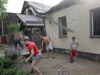 People are removing the debris following a nighttime Russian missile strike in Dnipro, Ukraine, on June 4, 2024. Ukraine's air defense force...